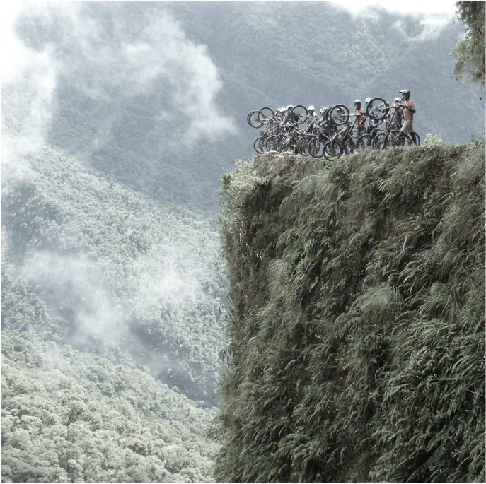 Biciclists at a very steep cliff